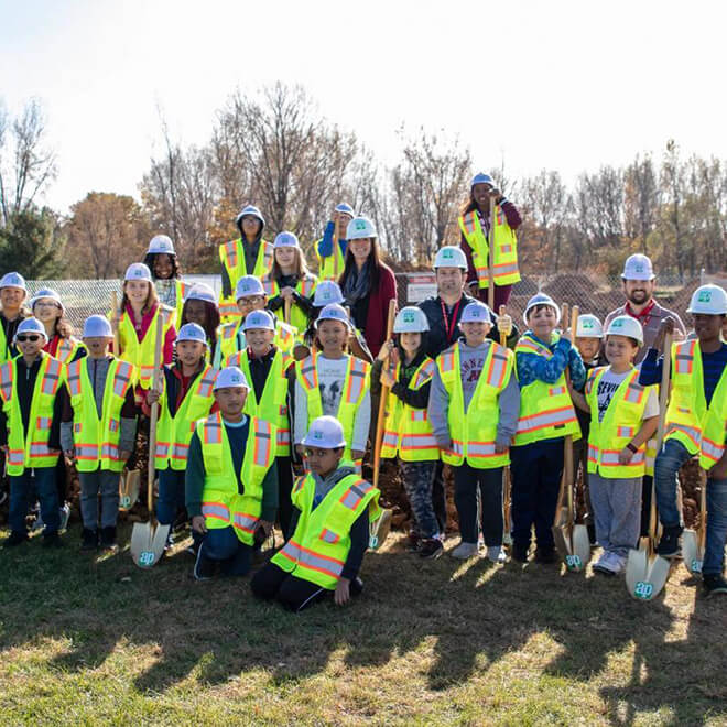 Group of kids in hard hats and vests